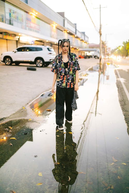 Woman with Pigtails Walks Through Puddle on the Street