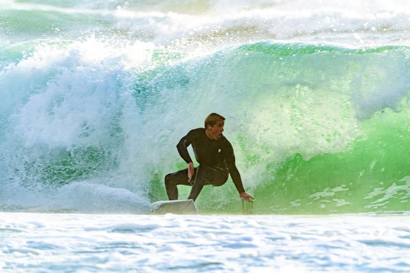 Surfer riding inside a barrel wave