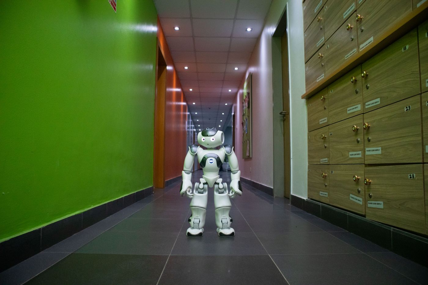 A humanoid robot stands in a vibrant, modern hallway in Lagos, Nigeria.