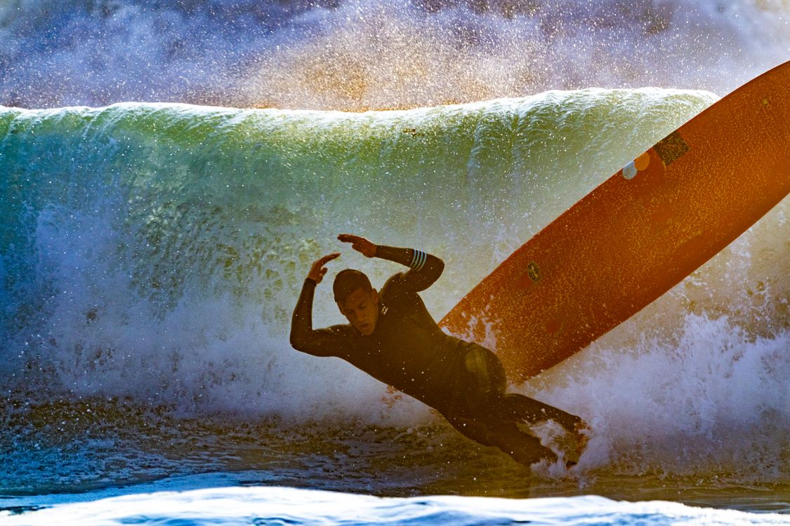 Man Wiping Out of Surfboard · Free Stock Photo