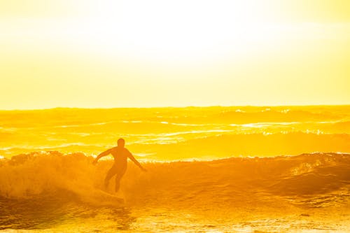 Man Surfing during Golden Hour