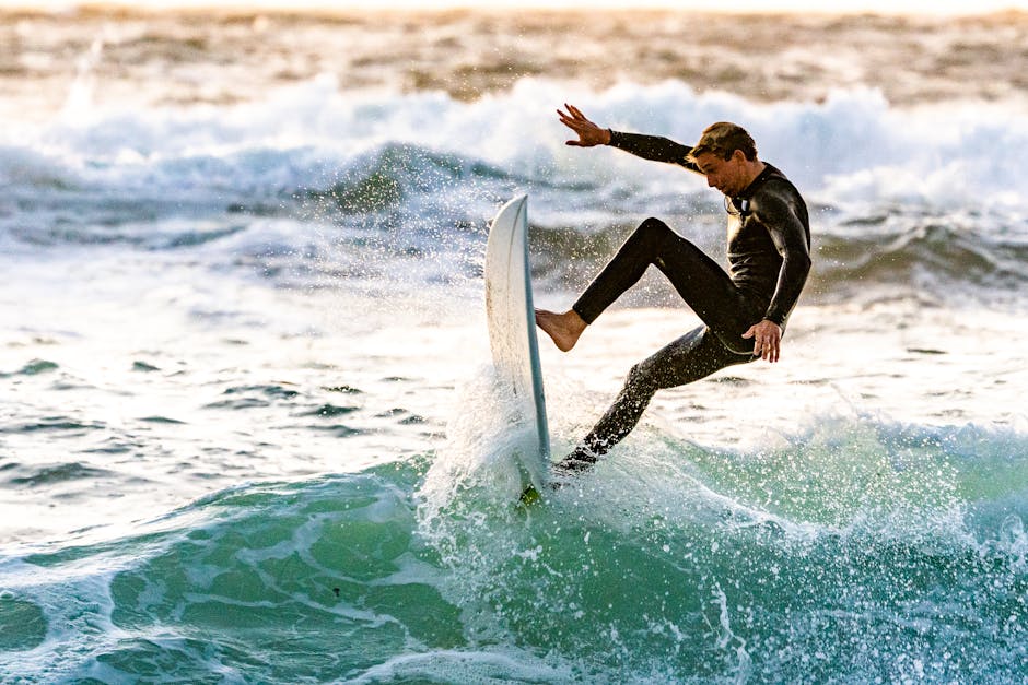 Energetic surfer performing a trick on ocean waves, showcasing skill and excitement.