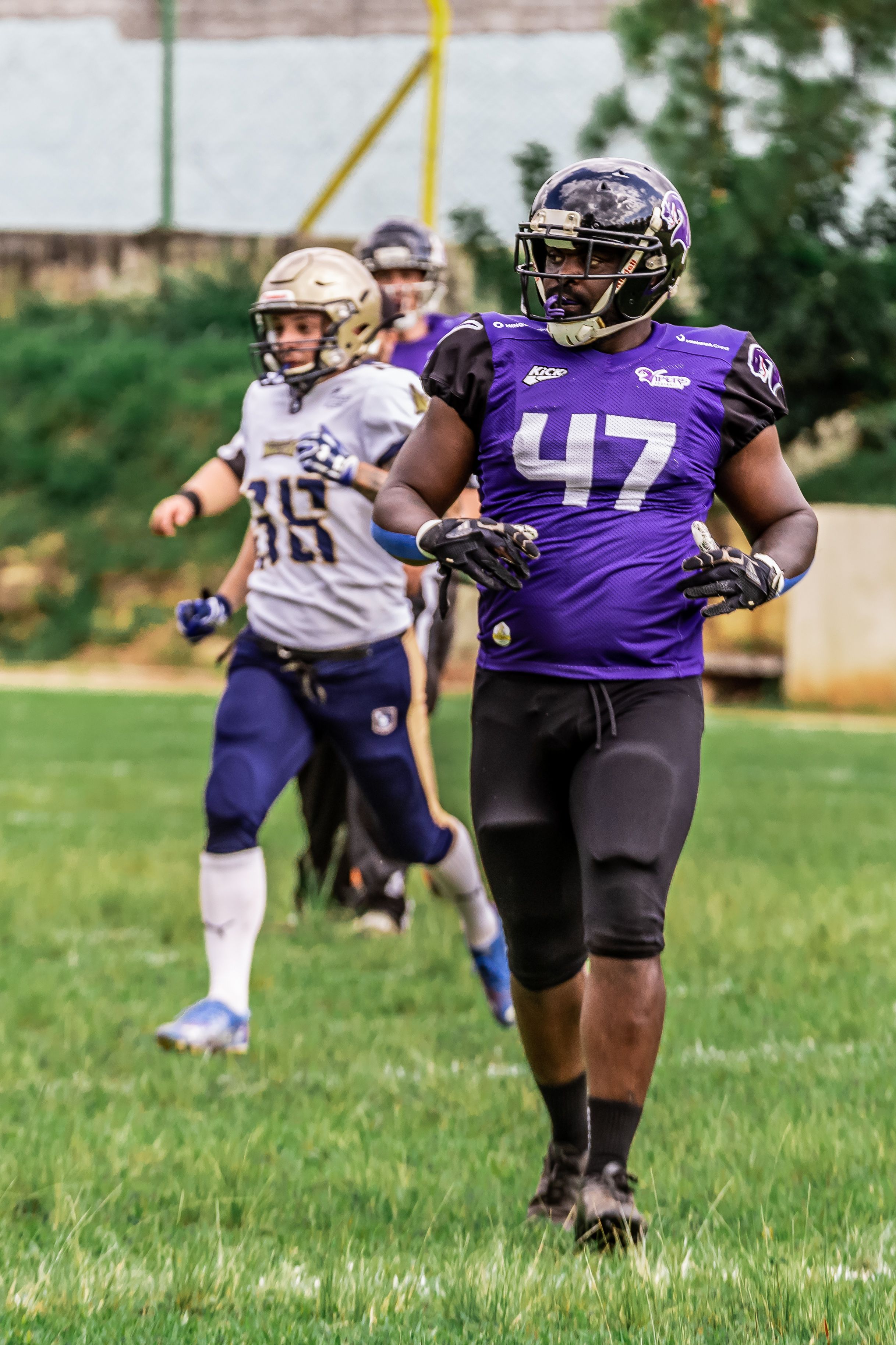 Athletes in action during an American football game, showcasing teamwork and competition.