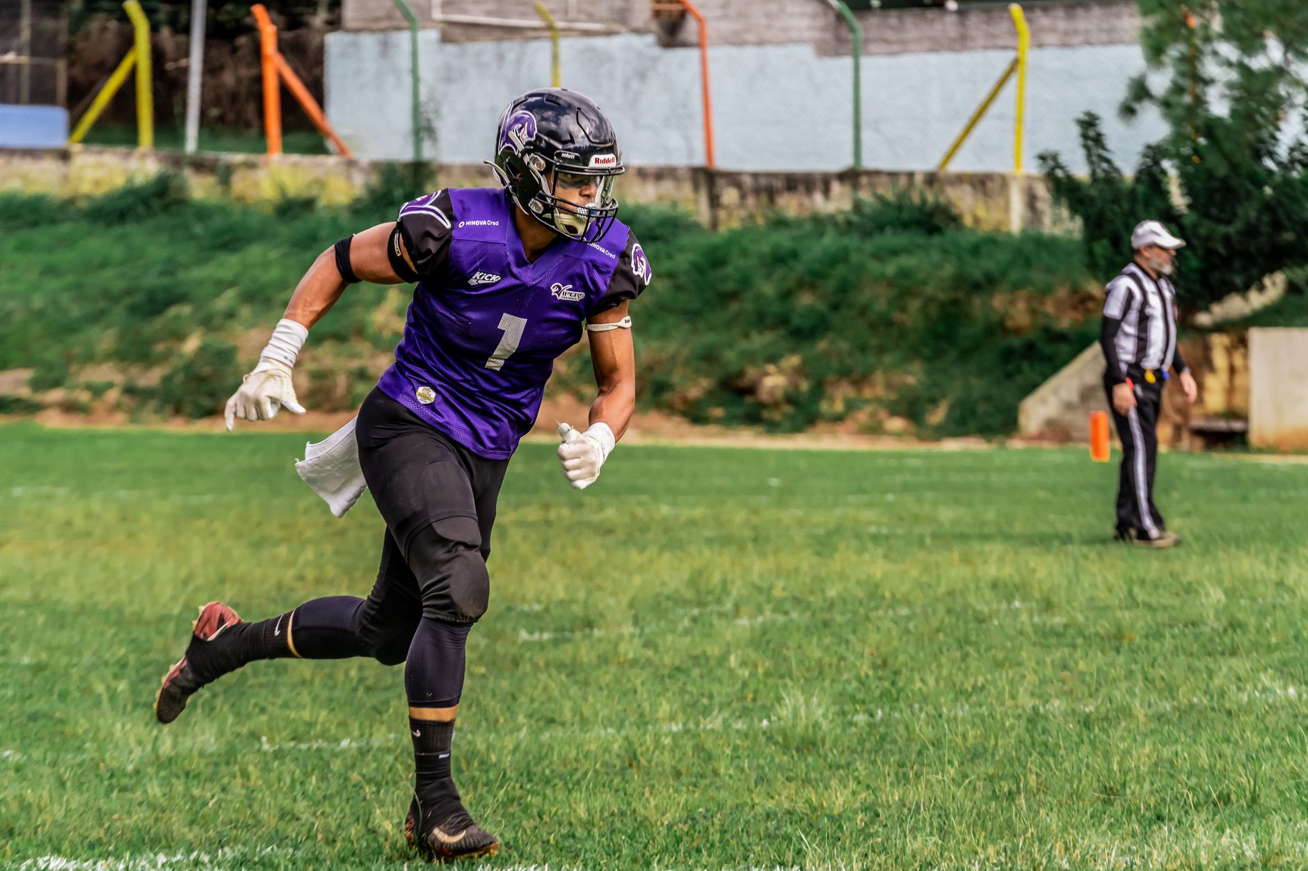 Dynamic shot of an American football player in action on the field.