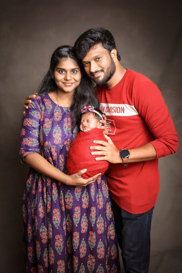 Parents Holding Their Newborn Baby 