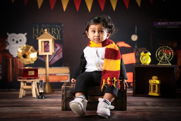 Child In Scarf Sitting On Chest