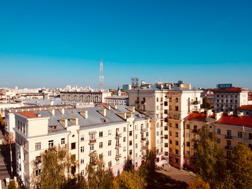 Free Aerial cityscape of residential buildings in Minsk with a clear blue sky. Stock Photo