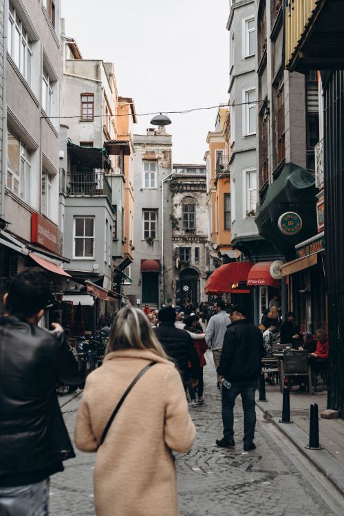 Free Crowded street in Istanbul with people walking between colorful residential buildings. Stock Photo