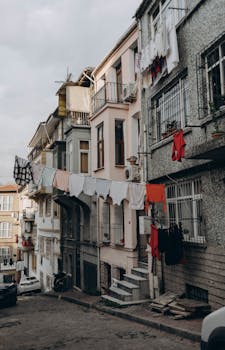 Istanbul residential street with colorful laundry hanging between historical buildings creating a vibrant urban scene.