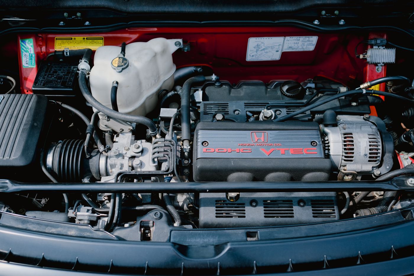 Mechanic checking a car's engine and cooling system for overheating