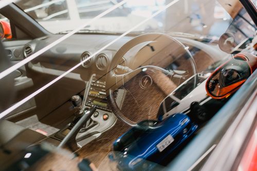 Free Interior view of a car showcasing the dashboard and reflections through the window. Stock Photo