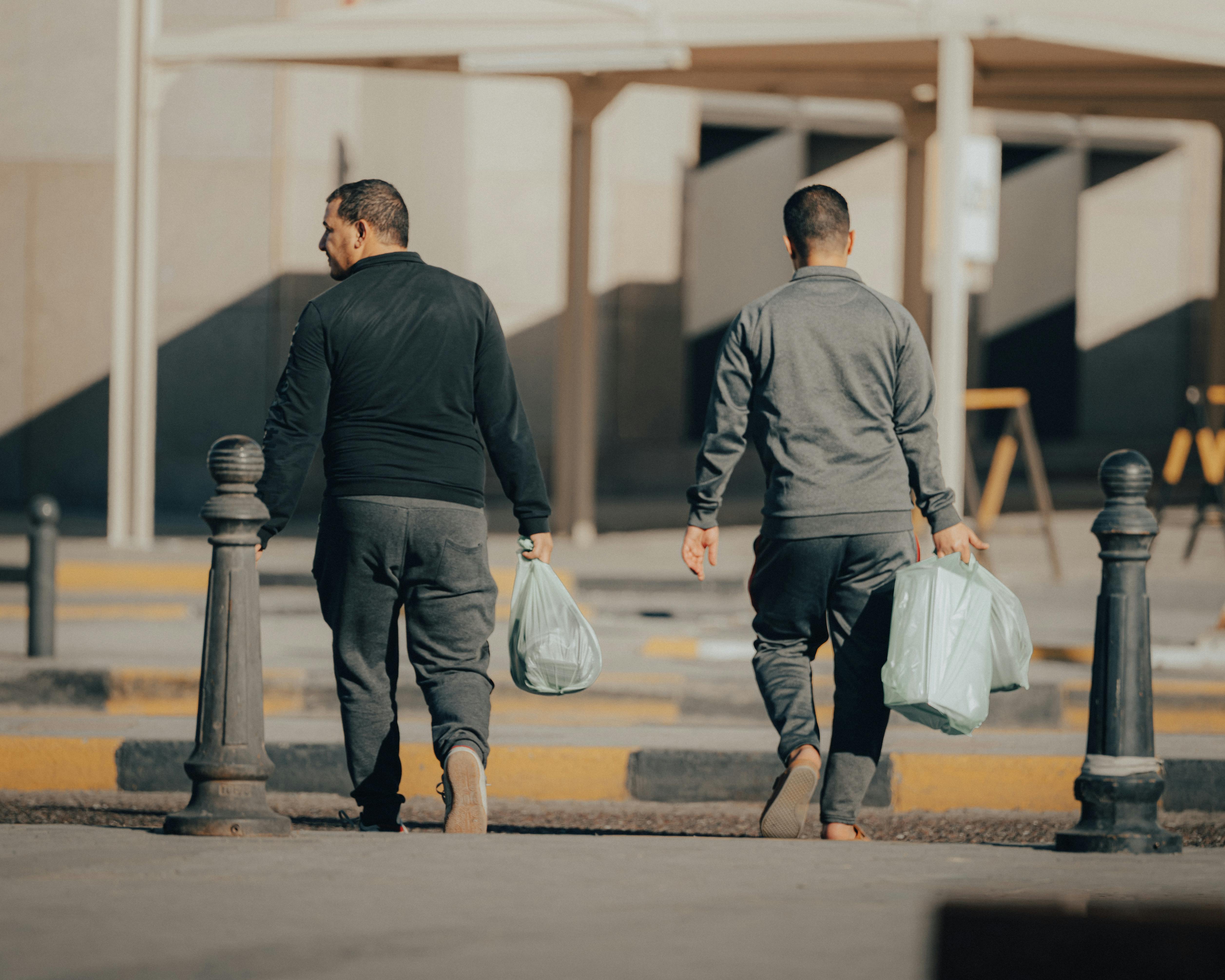 Men Carrying Bags on Street · Free Stock Photo