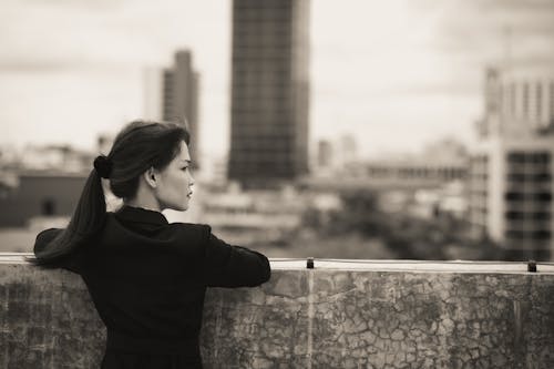 Woman Posing by Wall in City in Black and White