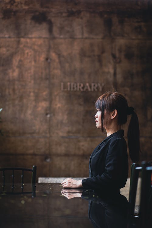 Woman Sitting and Posing by Table