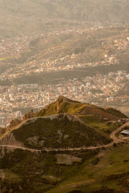 Breathtaking aerial view of La Paz, Bolivia with green hills and urban cityscape.