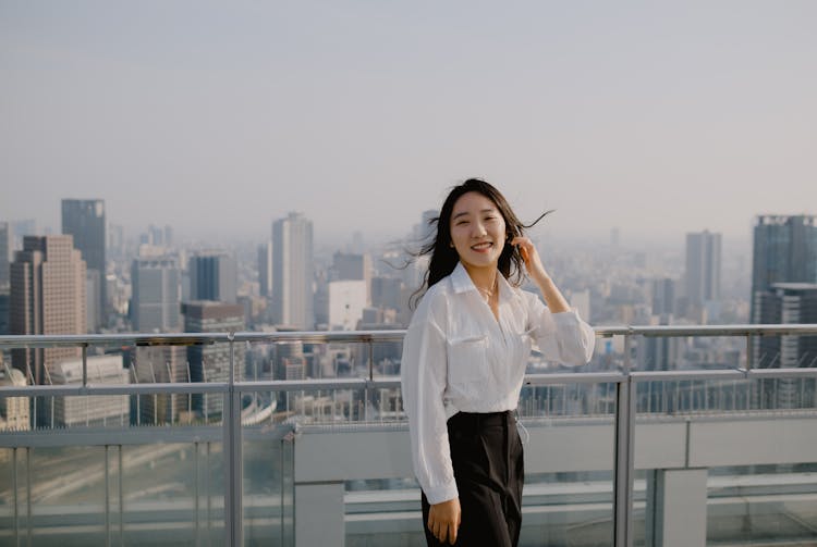 Brunette Woman In White Shirt On Rooftop