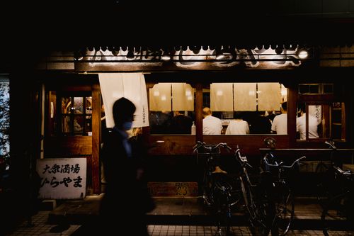 Free Candid view of a bustling Japanese street restaurant at night. Stock Photo
