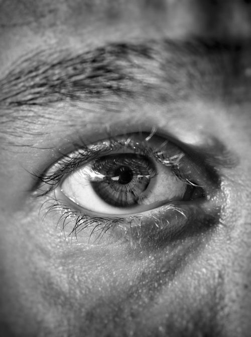 Free A striking black and white close-up of a human eye, highlighting the texture and detail. Stock Photo