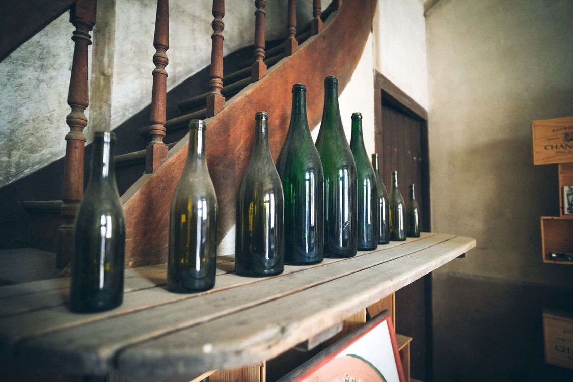 Old Wine Bottle on Wooden Shelf · Free Stock Photo