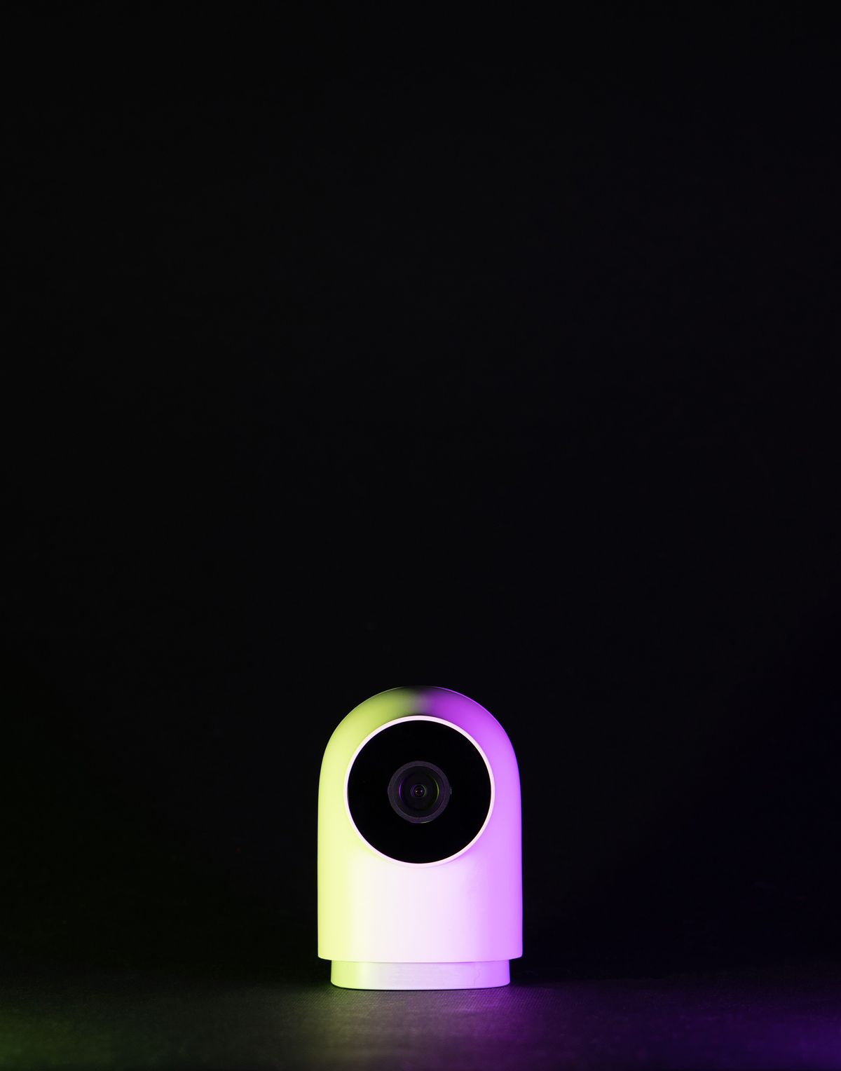Sleek white external webcam photographed against a dark background