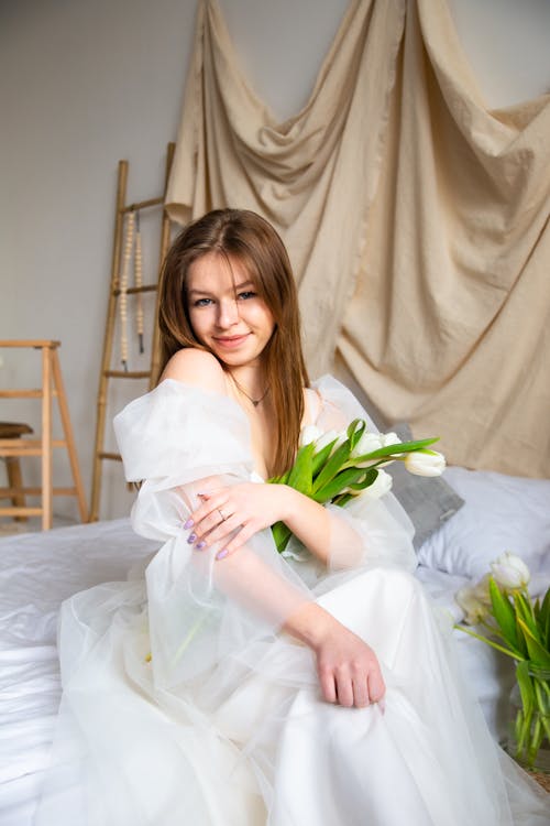 Smiling Young Woman in a White Dress