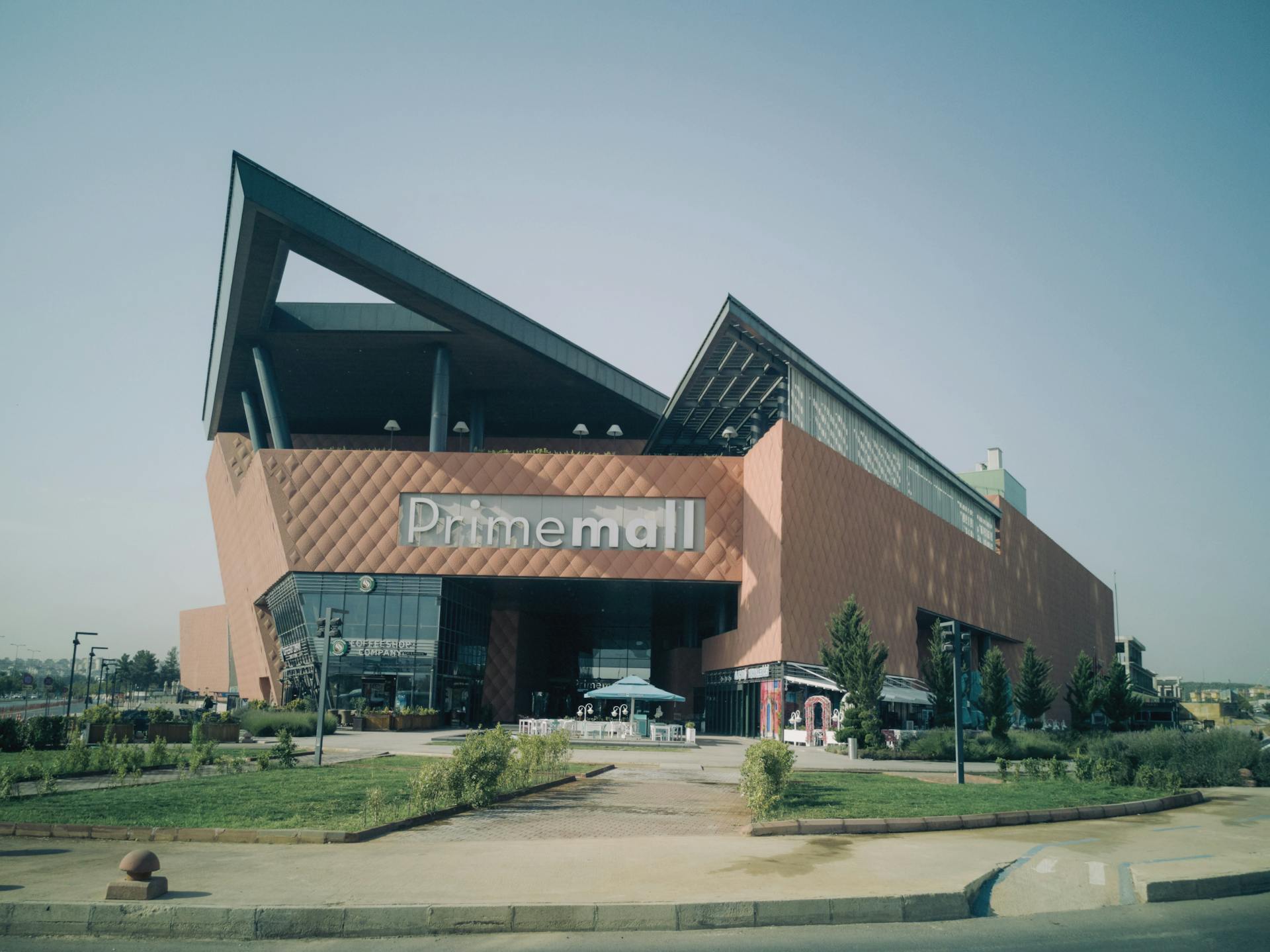 Exterior of modern Prime Mall shopping center in urban Turkey, showcasing architectural design.