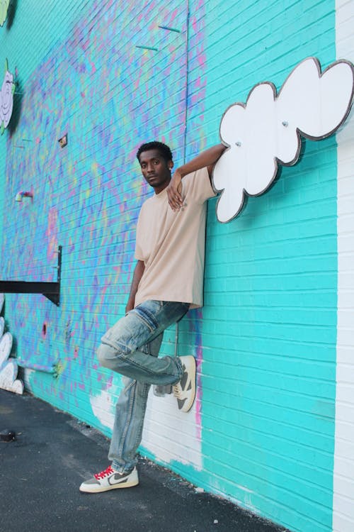 Male Model Leaning on a Brick Wall Covered in Graffiti