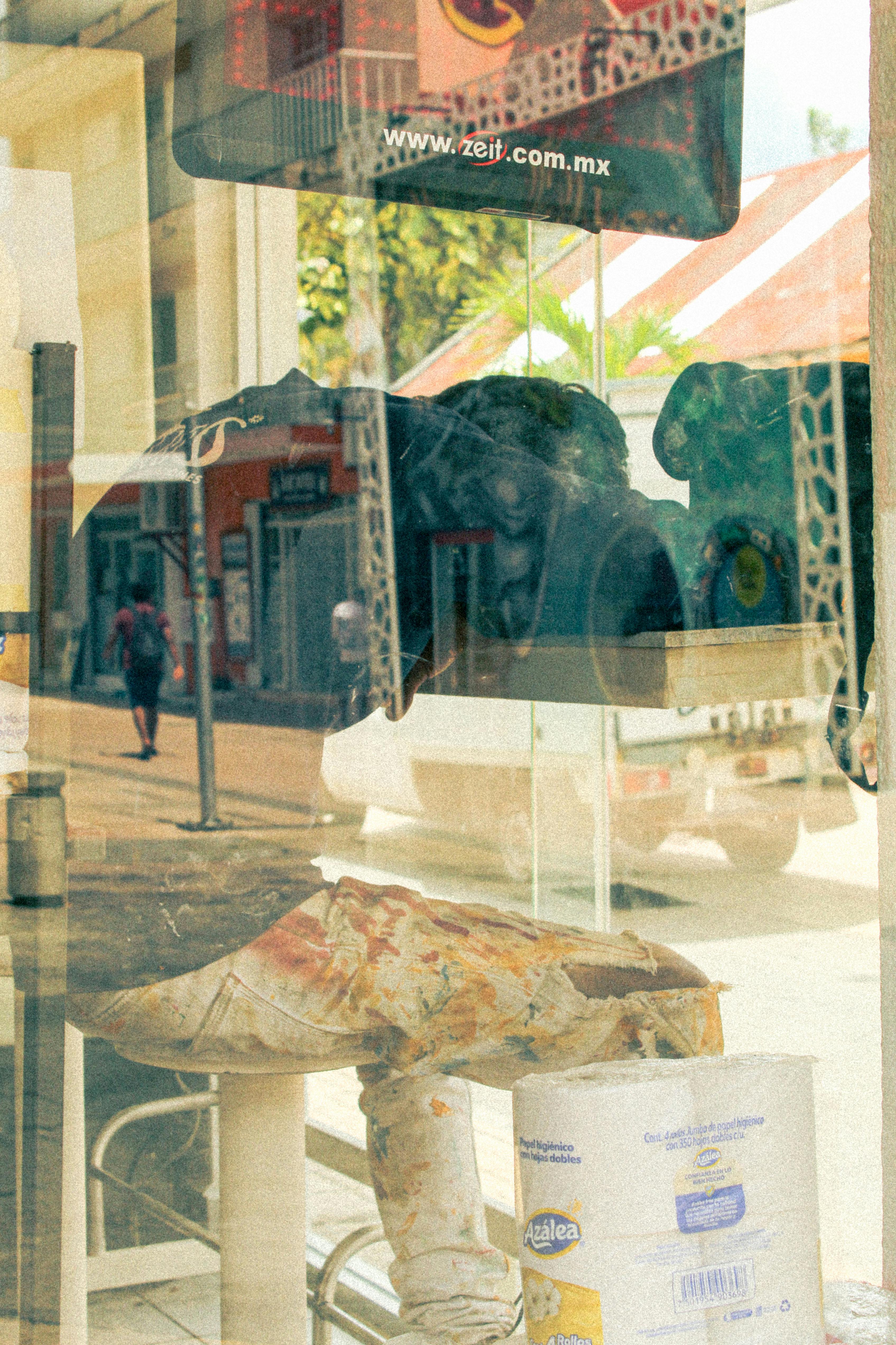 Unique street reflection in San Miguel de Cozumel showcasing vibrant local life and art.