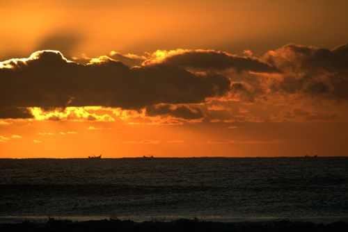 Free Dramatic sunset with golden hues over the sea in Guaratuba, Brazil. Stock Photo