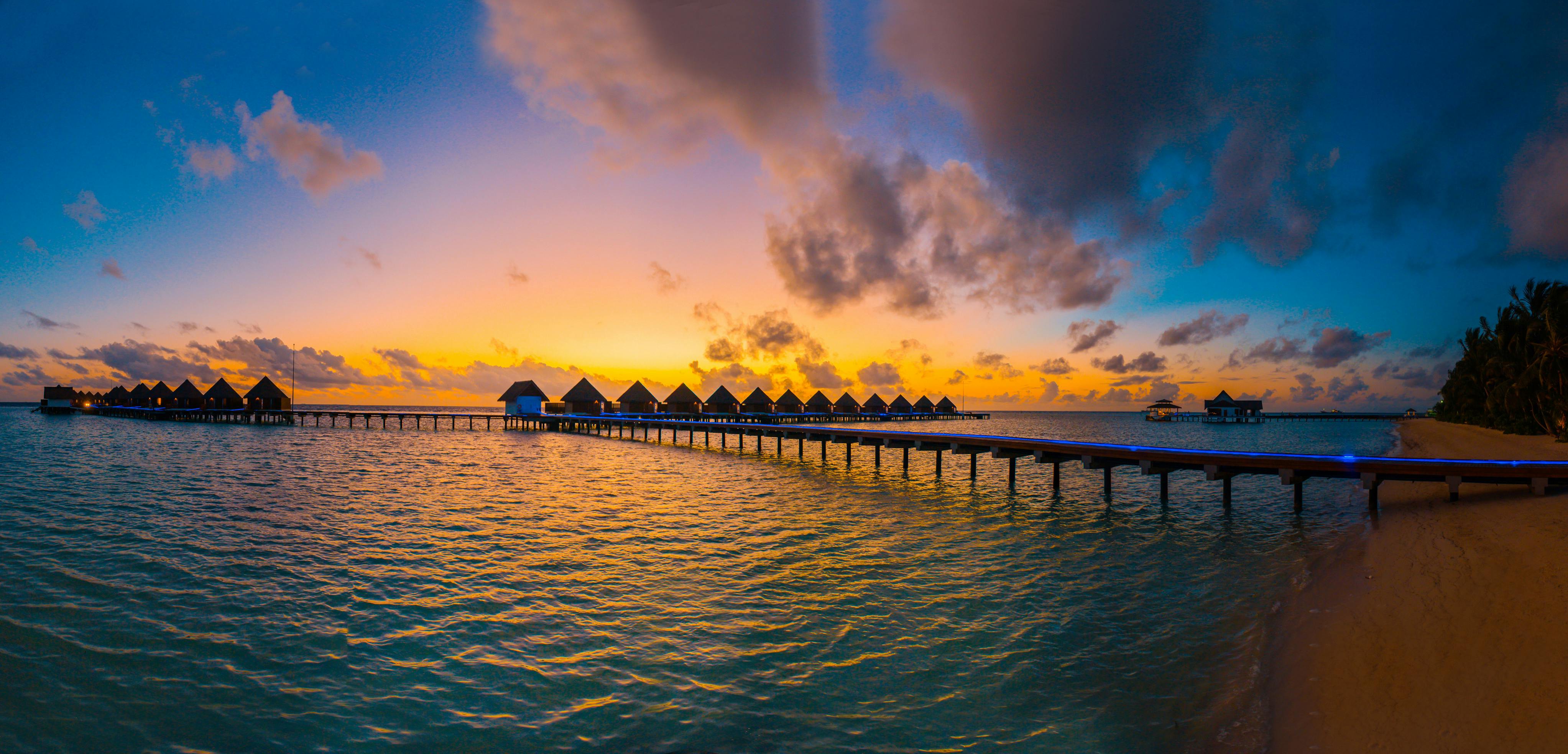 silhouette photography of in lined cottages in sea