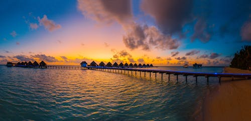 Silhouette Photography of In-lined Cottages in Sea