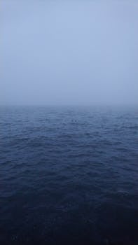 Eerie fog over the Caspian Sea creating a serene and mysterious horizon in Baku.