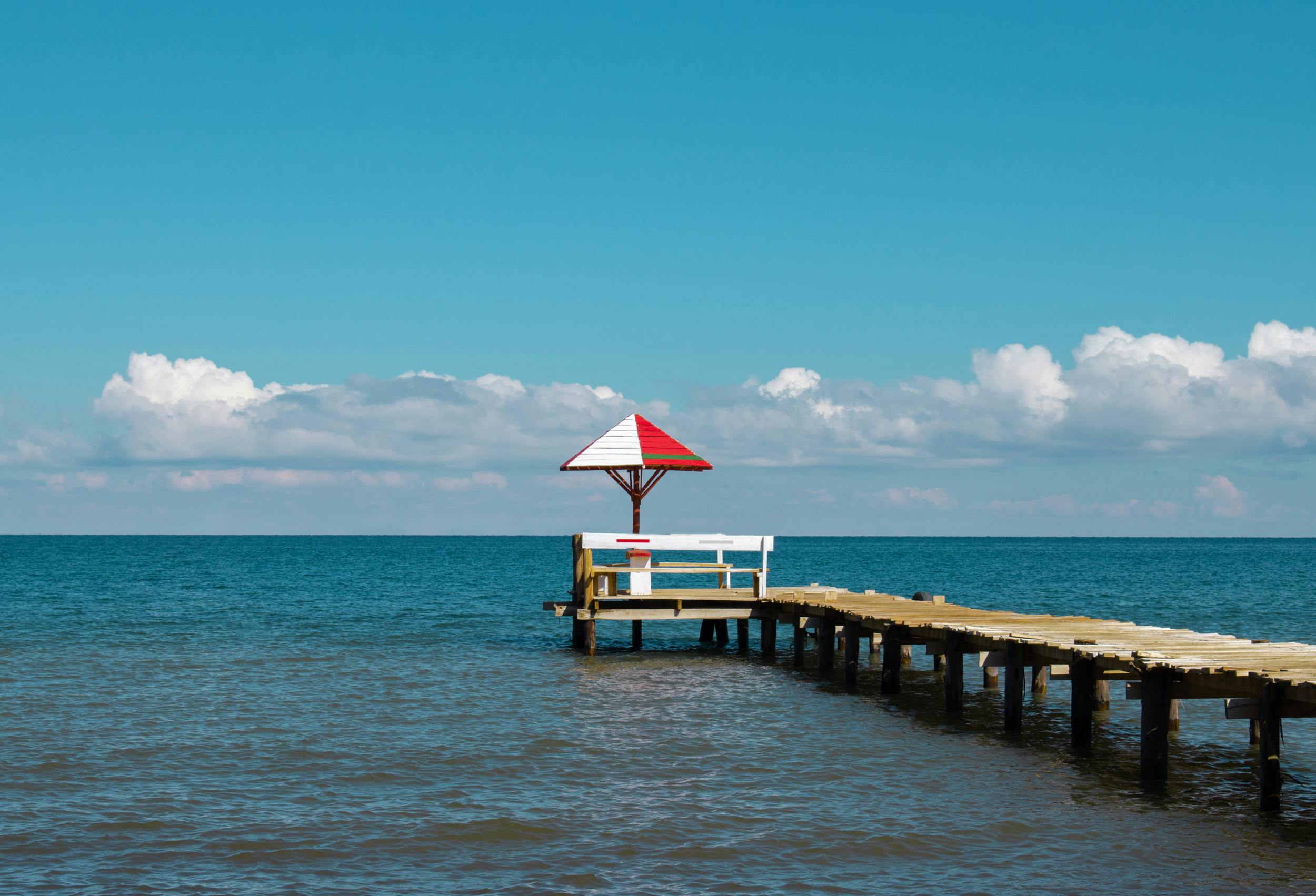 Idyllic wooden pier with umbrella overlooking tranquil sea, La Paz, Bolivia.