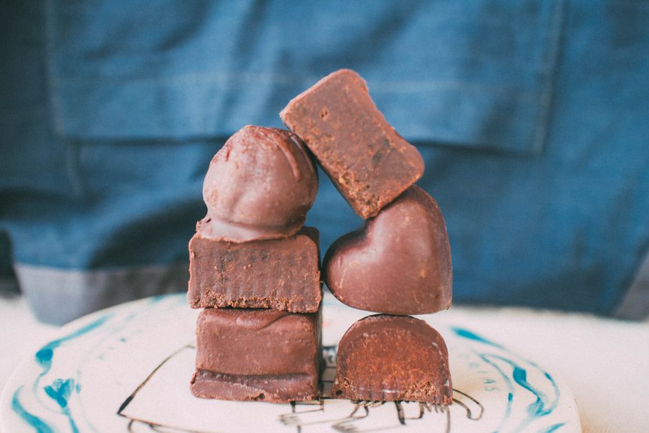 A close-up of various chocolates stacked creatively on a plate, perfect for food stock photography.