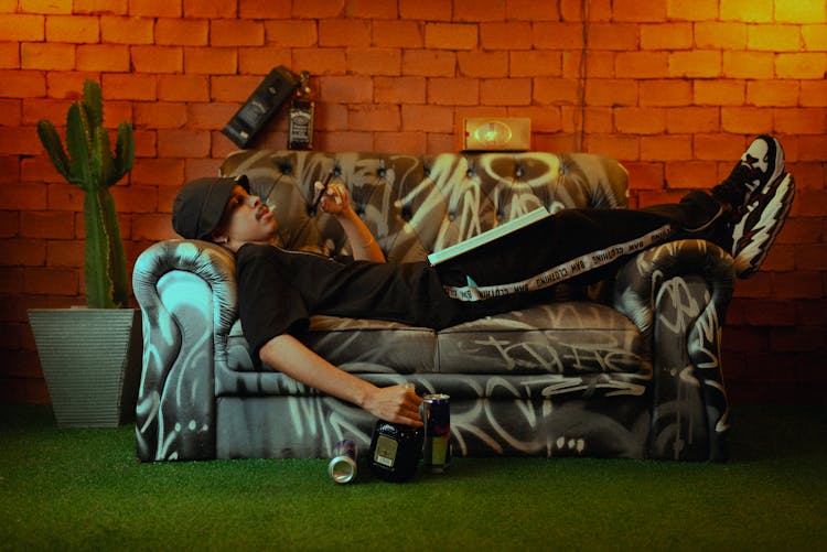 Man Lying Down With Cigar On Couch