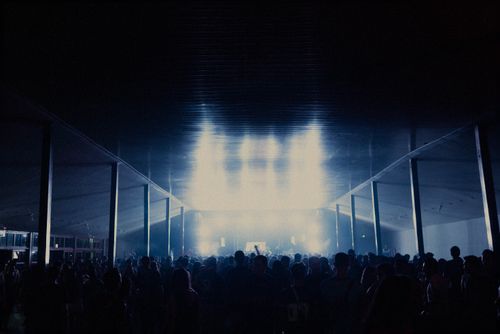 Free A lively indoor concert scene with a large, vibrant crowd under bright stage lights. Stock Photo