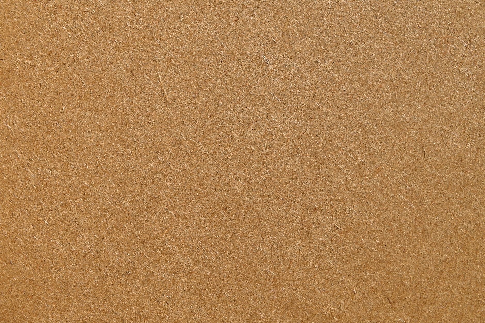 Detailed texture of a brown cardboard surface, ideal for backgrounds and design projects.