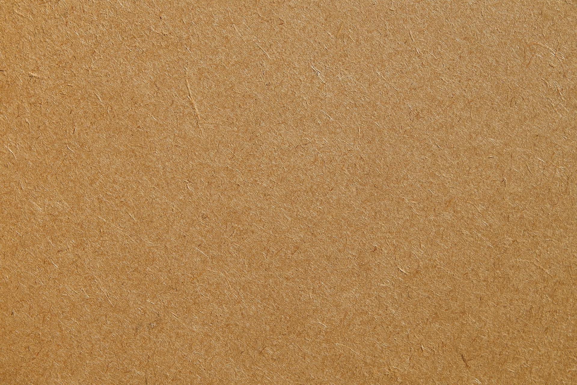 Detailed texture of a brown cardboard surface, ideal for backgrounds and design projects.