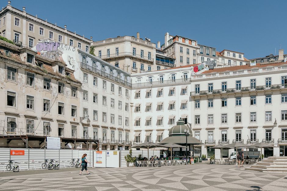 Person using free Wi-Fi at a cafe in a public square in Lisbon, Portugal