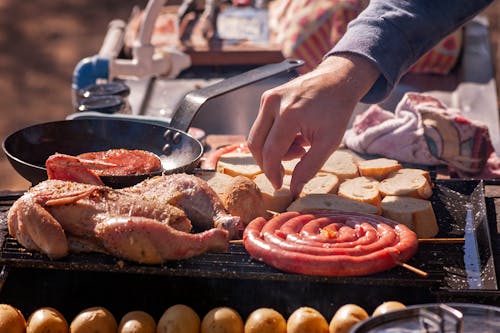 Man Cooking Food on Grill in Nature