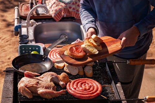 Man Cooking Food on Grill on Barbecue