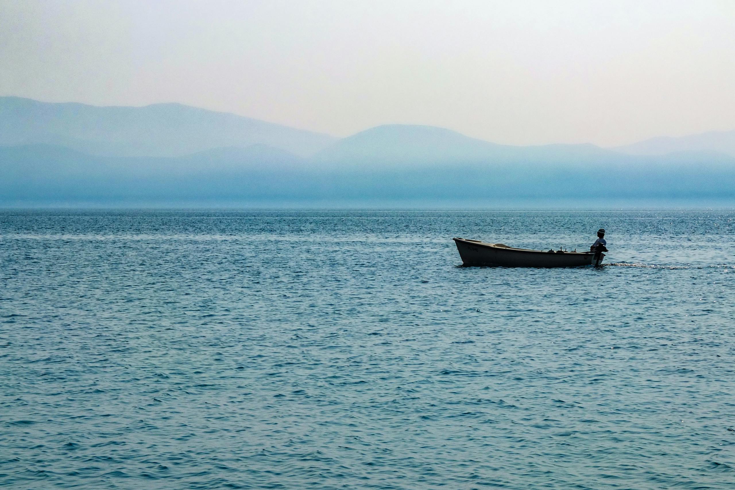 Lonely Boat on the Sea by Sun Pixel Photography