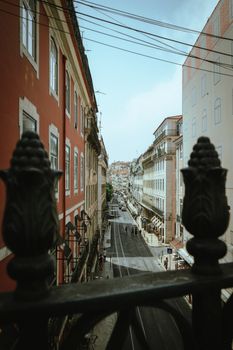 Explore the charming architecture and vibrant street life in Lisbon, Portugal, captured from a unique angle.