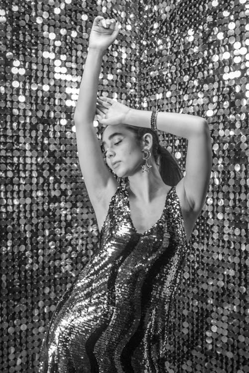 Dancing Woman Against Sequin Walls