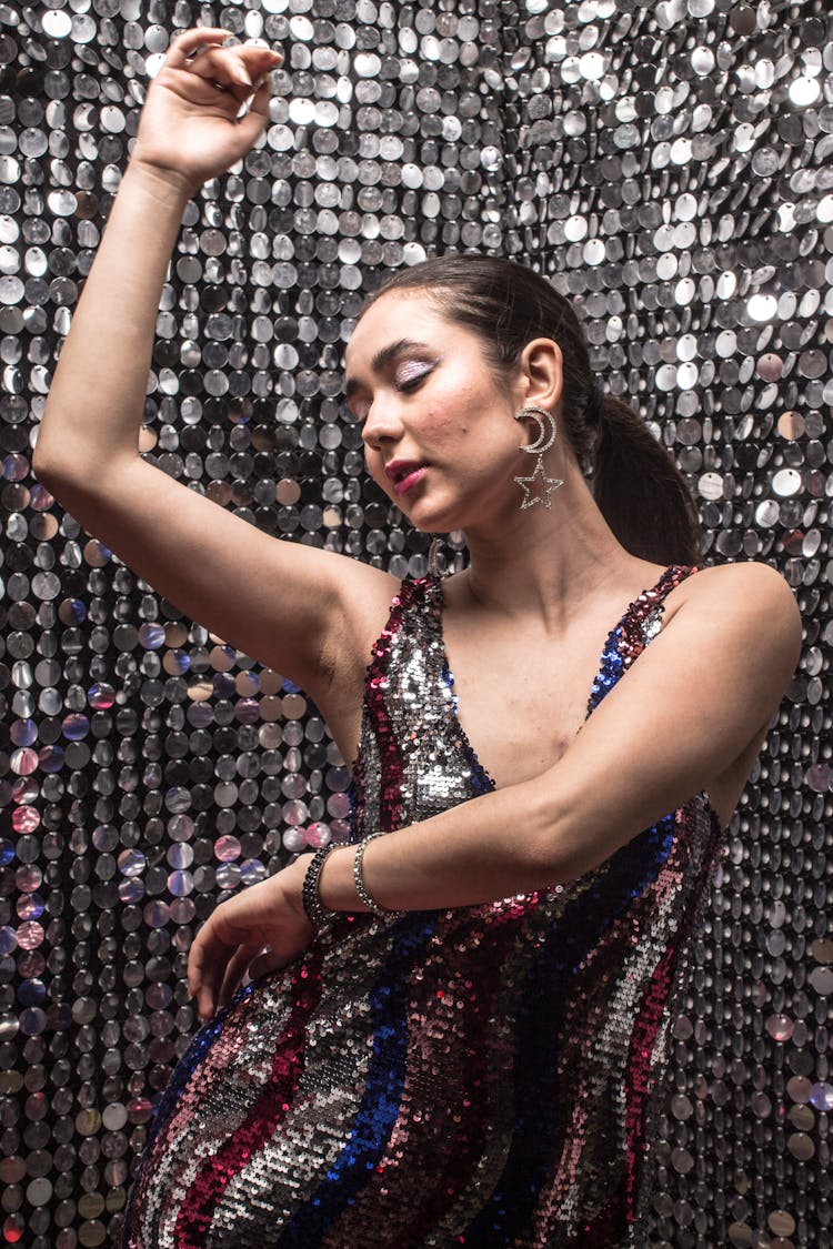 Young Woman In Glitter Dress Dancing In Disco Studio