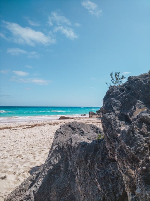 View of a Rock Formation on a Beach and a Blue Sea under Blue Sky