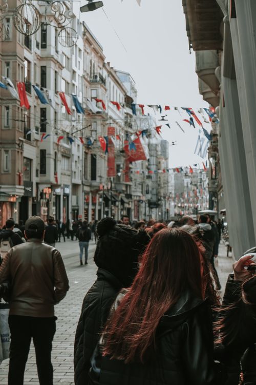 Free A vibrant street scene in Istanbul with a crowd and Turkish flags lining the street. Stock Photo