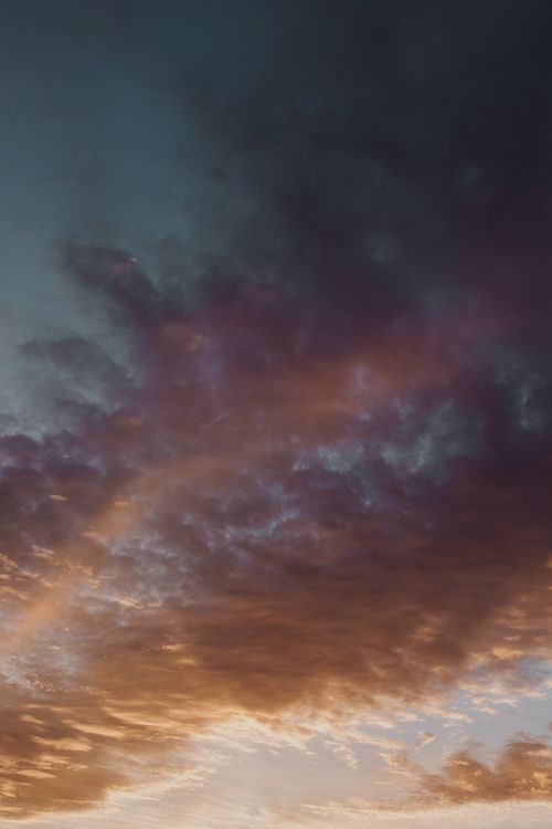 Free A captivating display of vibrant clouds at sunset, showcasing dramatic colors and textures. Stock Photo