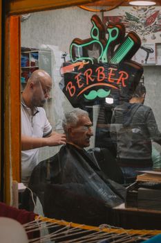 A glimpse into a classic barbershop in Ankara, showcasing a barber at work.