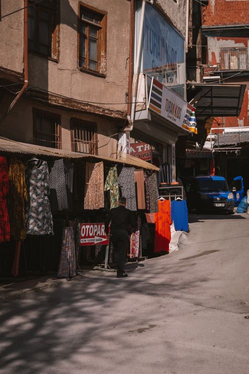 Free Colorful textiles and urban life in a bustling Ankara market street. Stock Photo